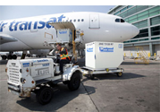 A photograph of an aeroplane being loading with freight